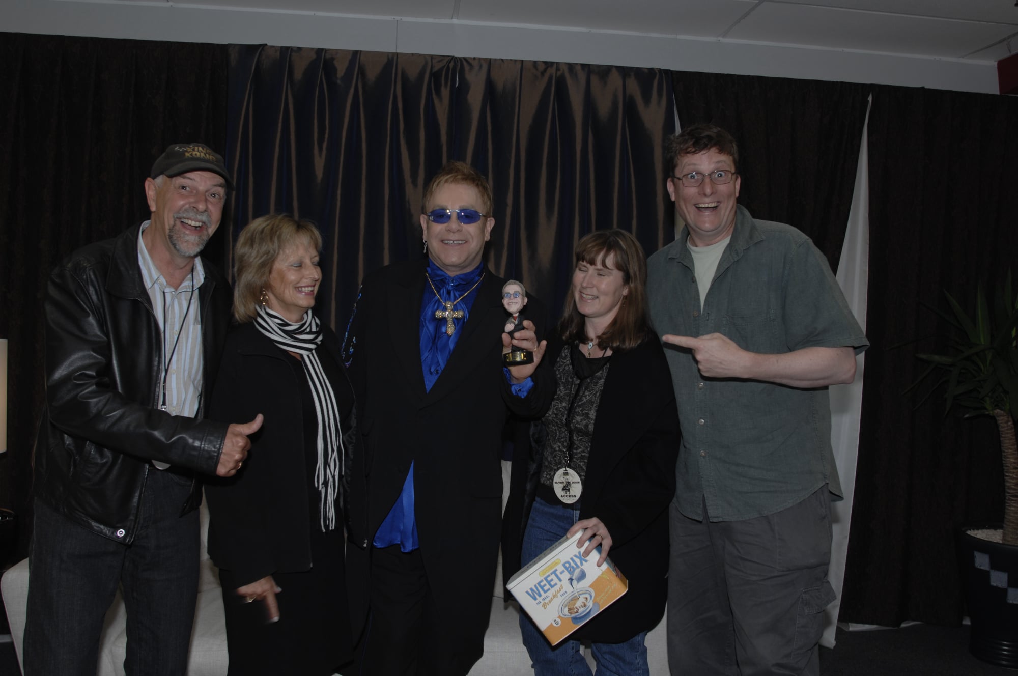 Richard Taylor presenting a gift to Elton John backstage in New Zealand.
